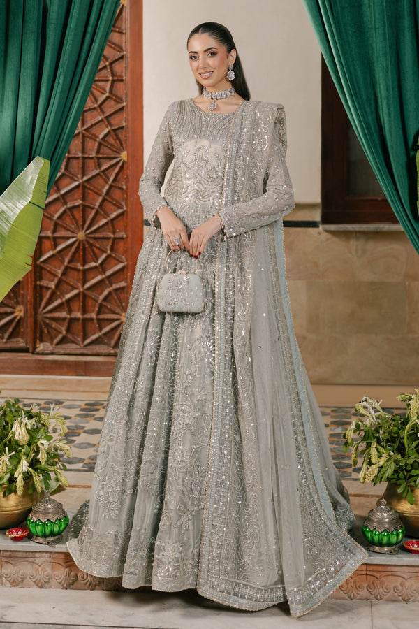 NAQSHI Arminha silver-grey net maxi frock with full sleeves, unique neckline and heavily hand-embellished bodice featuring stones, pearls, crystals, sitara & thread embroidery, paired with matching net dupatta.